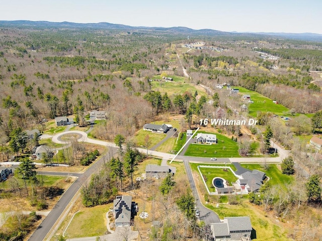 bird's eye view featuring a wooded view