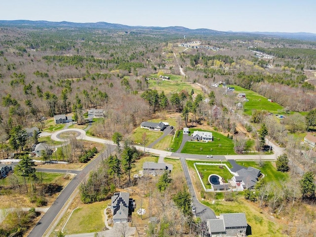 birds eye view of property with a view of trees and a mountain view