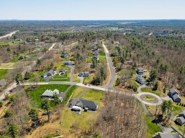 drone / aerial view featuring a forest view