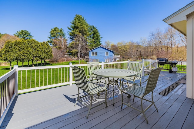 wooden terrace featuring a lawn