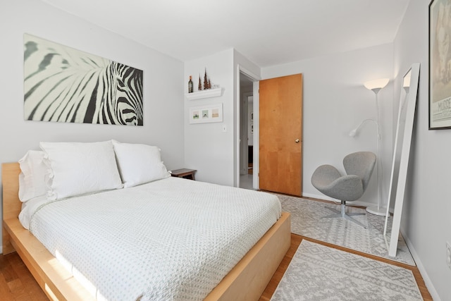 bedroom featuring baseboards and wood finished floors