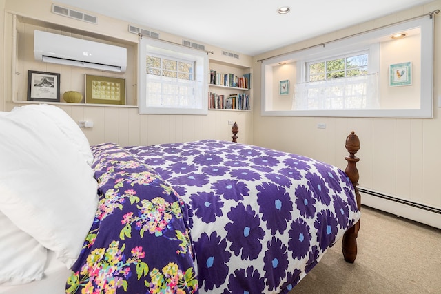carpeted bedroom featuring an AC wall unit, a baseboard radiator, and visible vents