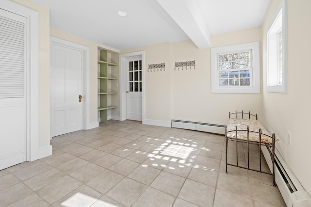 interior space with baseboards, a baseboard radiator, baseboard heating, and built in shelves
