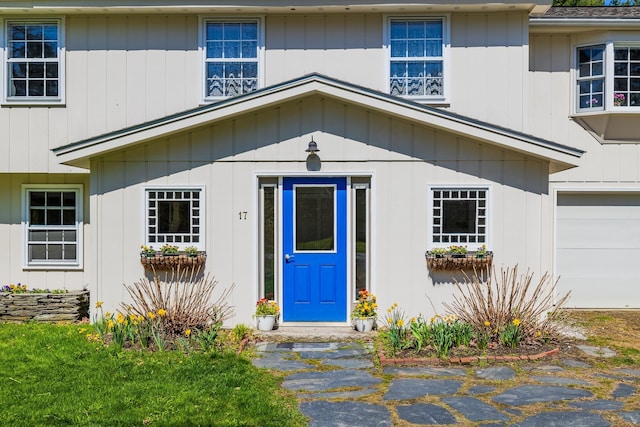 doorway to property with a garage