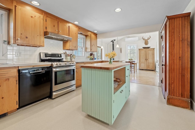 kitchen with decorative backsplash, a wall mounted air conditioner, black dishwasher, stainless steel electric range, and under cabinet range hood