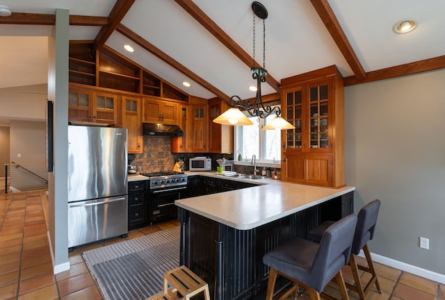 3 Augusta National # 145, Bedford, NH 03110 - kitchen featuring backsplash, a sink, a peninsula, under cabinet range hood, and stainless steel appliances