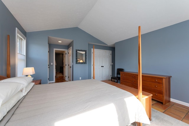 3 Augusta National # 145, Bedford, NH 03110 - tiled bedroom featuring a closet, baseboards, and vaulted ceiling