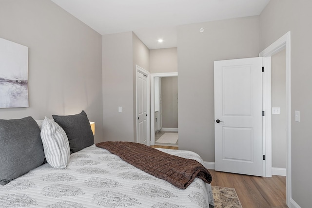 bedroom with baseboards, recessed lighting, and wood finished floors