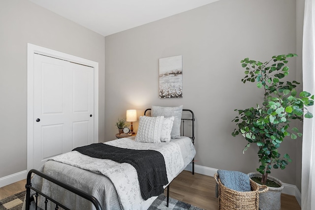 bedroom featuring baseboards and wood finished floors
