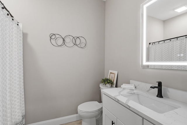 bathroom featuring vanity, a shower with curtain, and toilet