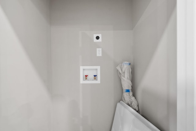 clothes washing area with washer hookup, hookup for an electric dryer, and laundry area