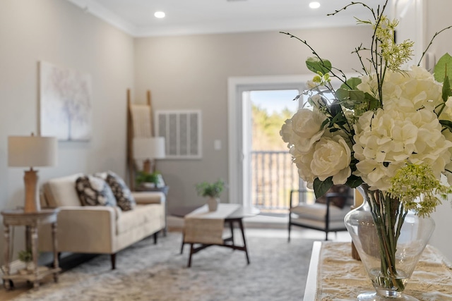 carpeted living area with visible vents, recessed lighting, and crown molding
