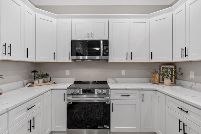 kitchen featuring white cabinetry, light stone countertops, and appliances with stainless steel finishes
