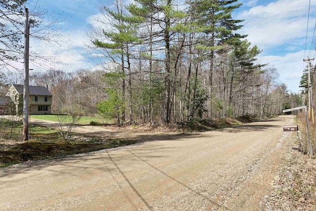view of road with a wooded view
