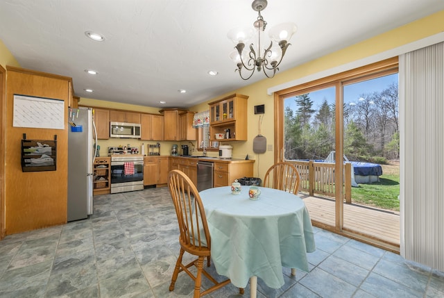 dining area featuring recessed lighting, a chandelier, and stone finish floor