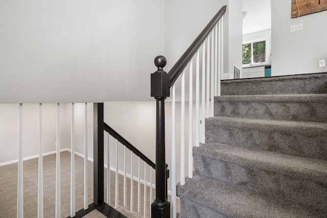 staircase with visible vents and carpet flooring
