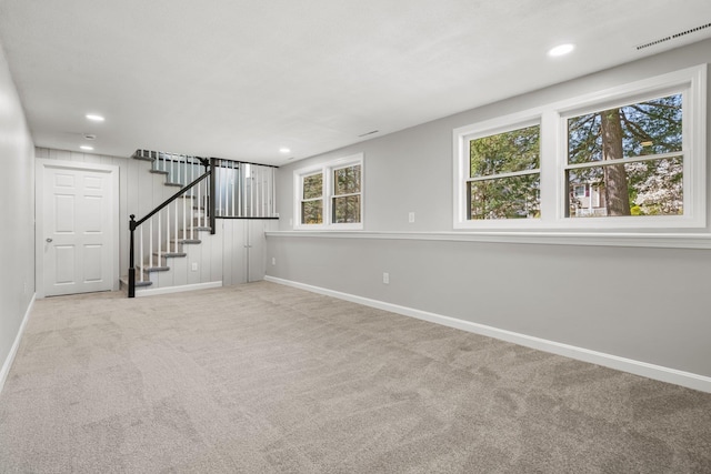 unfurnished living room featuring visible vents, stairs, baseboards, recessed lighting, and carpet