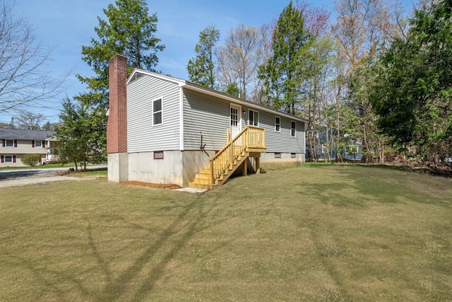 back of property featuring a yard and a chimney