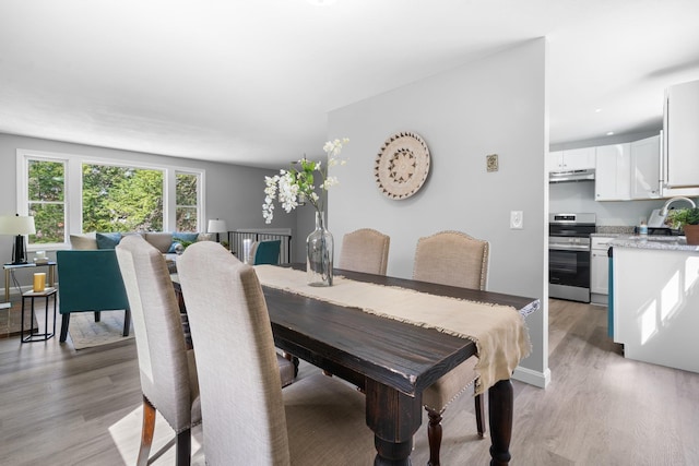 dining space with light wood-style flooring