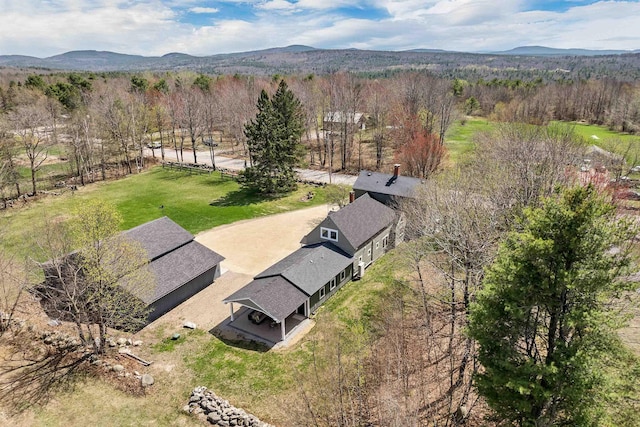 birds eye view of property with a forest view and a mountain view