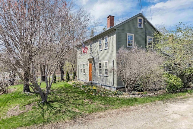view of side of home with a chimney