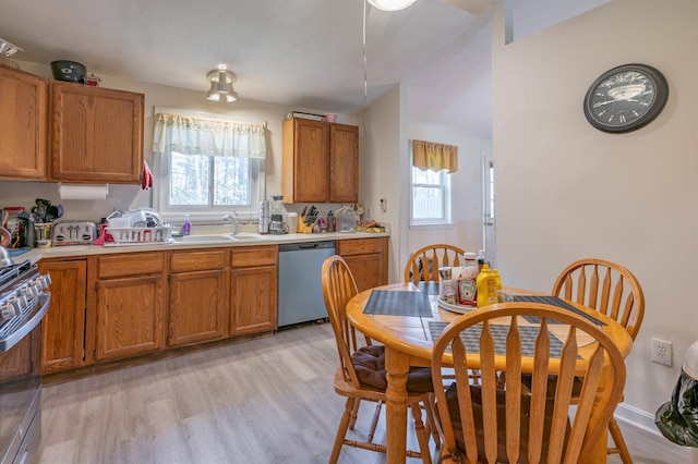 kitchen featuring plenty of natural light, light countertops, appliances with stainless steel finishes, and light wood-type flooring