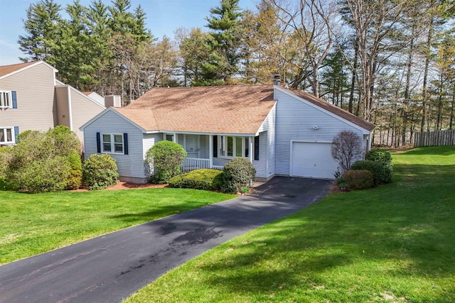 ranch-style house with an attached garage, aphalt driveway, a porch, a front yard, and a chimney