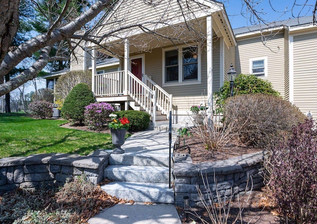 view of front of property featuring a porch, stairway, and a front yard