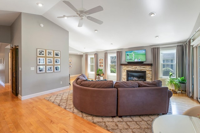 living area featuring vaulted ceiling, a wealth of natural light, and light wood-type flooring