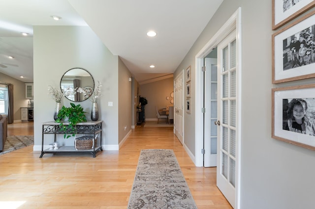 corridor featuring recessed lighting, light wood-style flooring, and baseboards