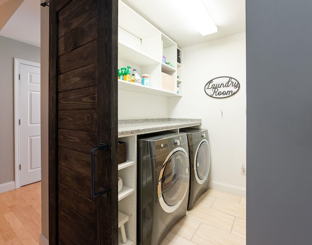 laundry area featuring baseboards, laundry area, and washer and clothes dryer