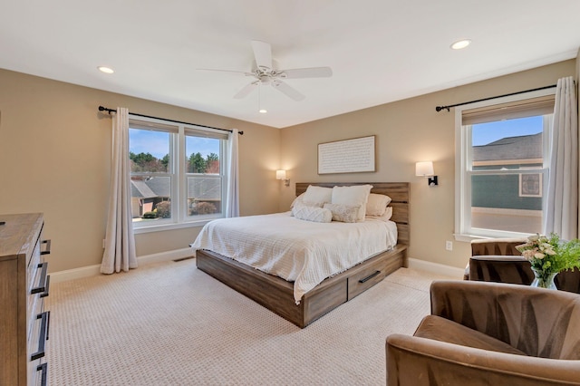 bedroom with baseboards, recessed lighting, and light carpet