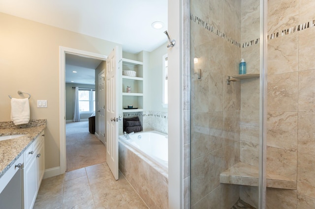 full bath featuring vanity, tile patterned floors, a garden tub, and a shower stall