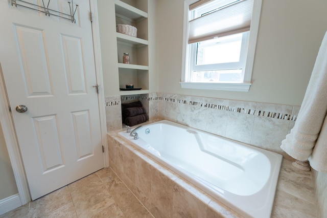 full bathroom with a garden tub and built in shelves