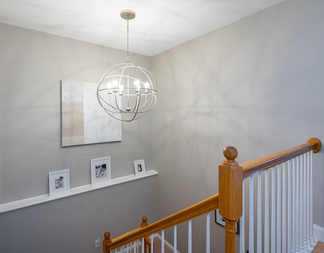staircase featuring an inviting chandelier