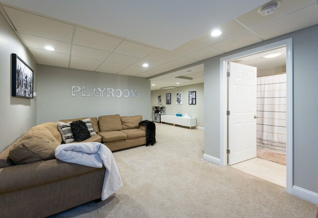 living area with carpet floors, recessed lighting, baseboards, and a paneled ceiling