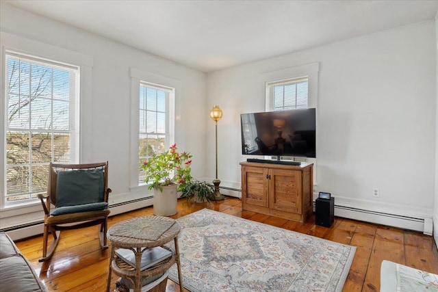 16 Manchester St Unit 2, Pittsfield, NH 03263 - living room featuring baseboard heating and hardwood / wood-style flooring