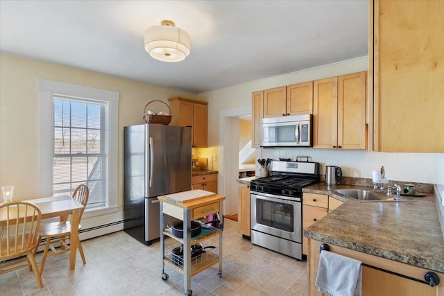 16 Manchester St Unit 2, Pittsfield, NH 03263 - kitchen with light brown cabinetry, dark countertops, tasteful backsplash, a sink, and stainless steel appliances