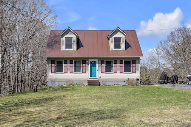 new england style home with a front yard, metal roof, and entry steps