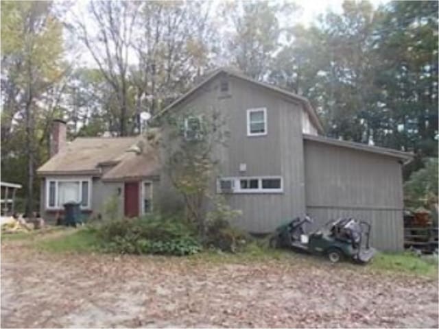 view of front of house featuring a chimney