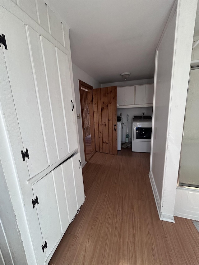 corridor featuring washer / dryer and wood finished floors