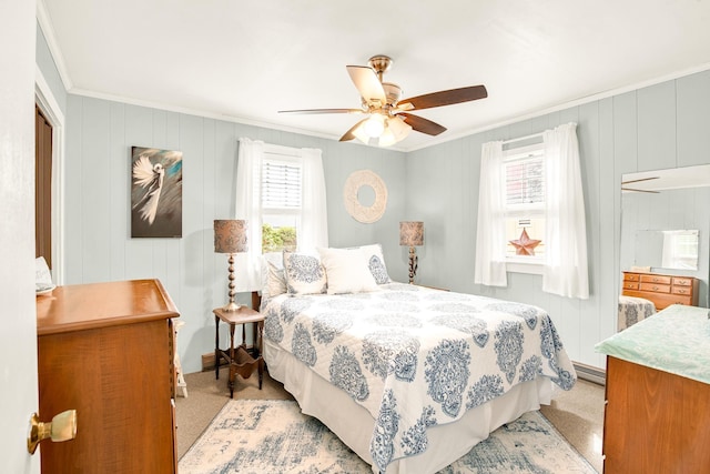 carpeted bedroom featuring ceiling fan and ornamental molding