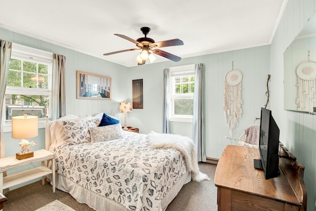 carpeted bedroom with ornamental molding and a ceiling fan