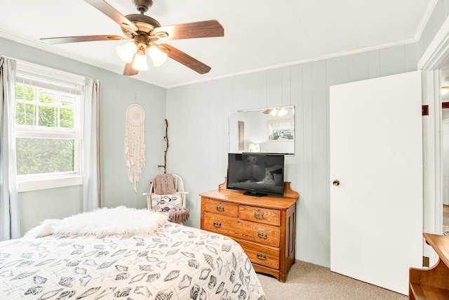bedroom with crown molding, a ceiling fan, and light colored carpet