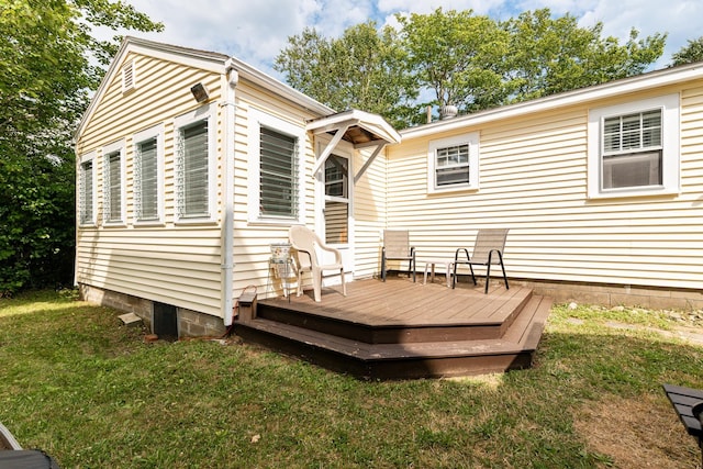 rear view of house featuring a lawn and a wooden deck