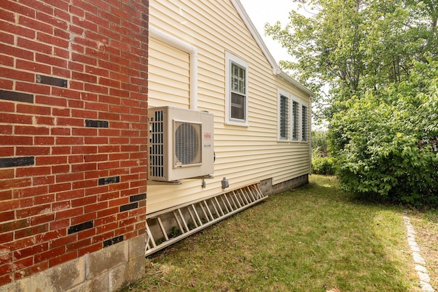 view of home's exterior featuring ac unit, a yard, and crawl space