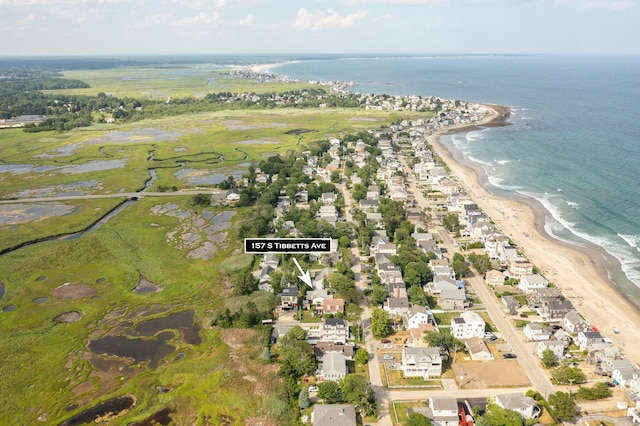 drone / aerial view featuring a residential view, a view of the beach, and a water view