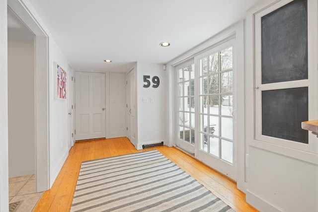 doorway to outside with visible vents, wood-type flooring, and recessed lighting