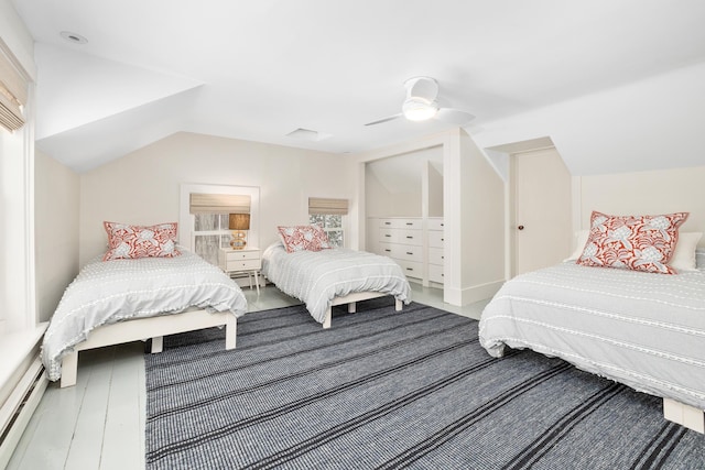 bedroom featuring vaulted ceiling, ceiling fan, and baseboard heating