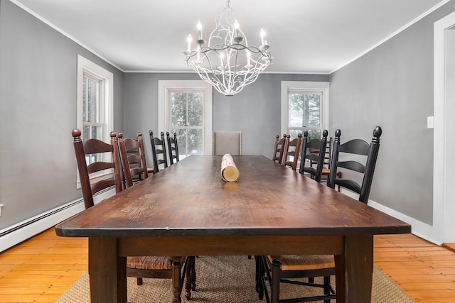 dining room with a notable chandelier, ornamental molding, and a healthy amount of sunlight